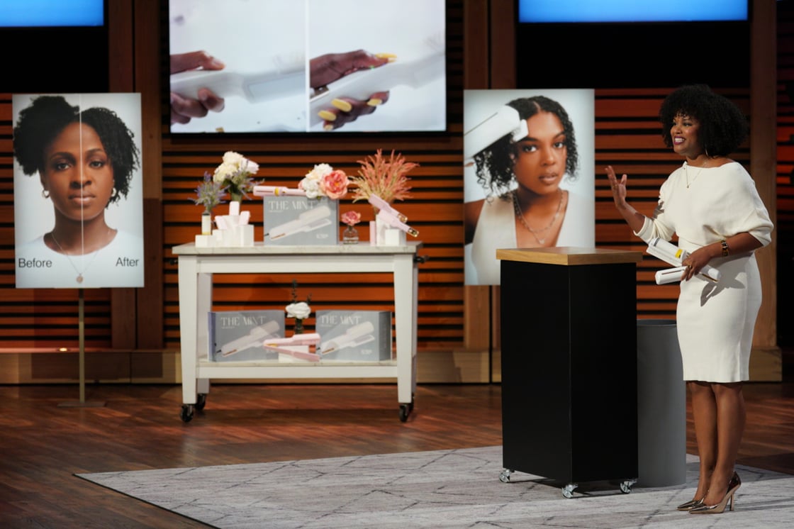 Dawn Myers in white dress on 'Shark Tank' demonstrating her company's products