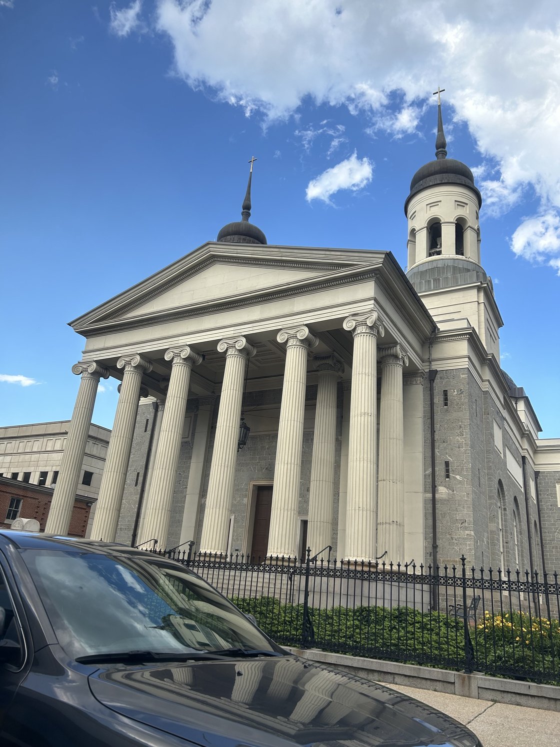 Catholic basilica in beige stone with brown domes