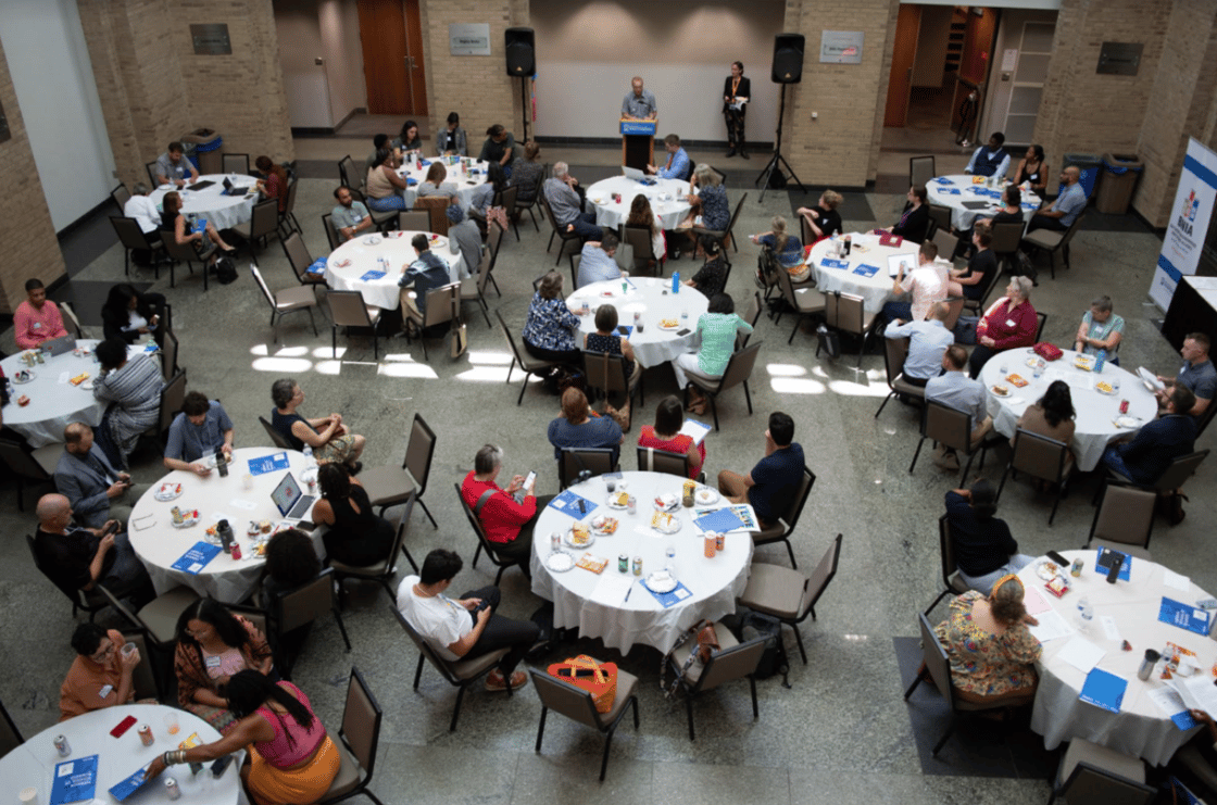 Crowds at white circular tables