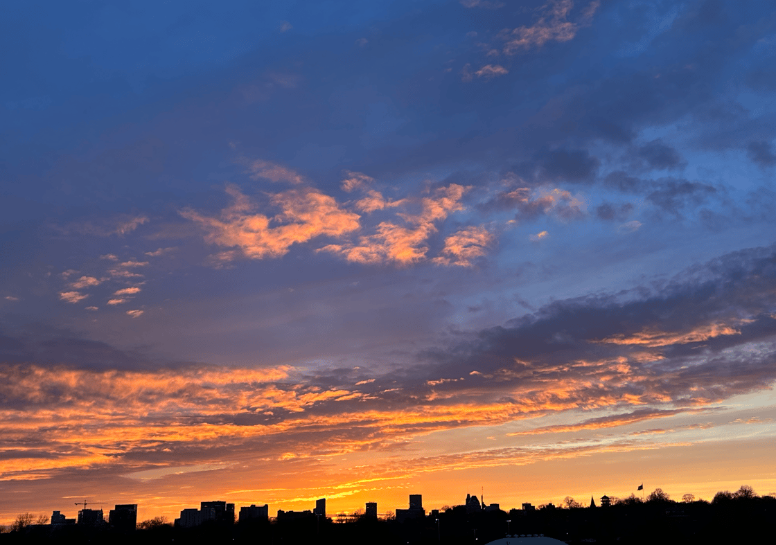 Baltimore's skyline below a blue and orange sky